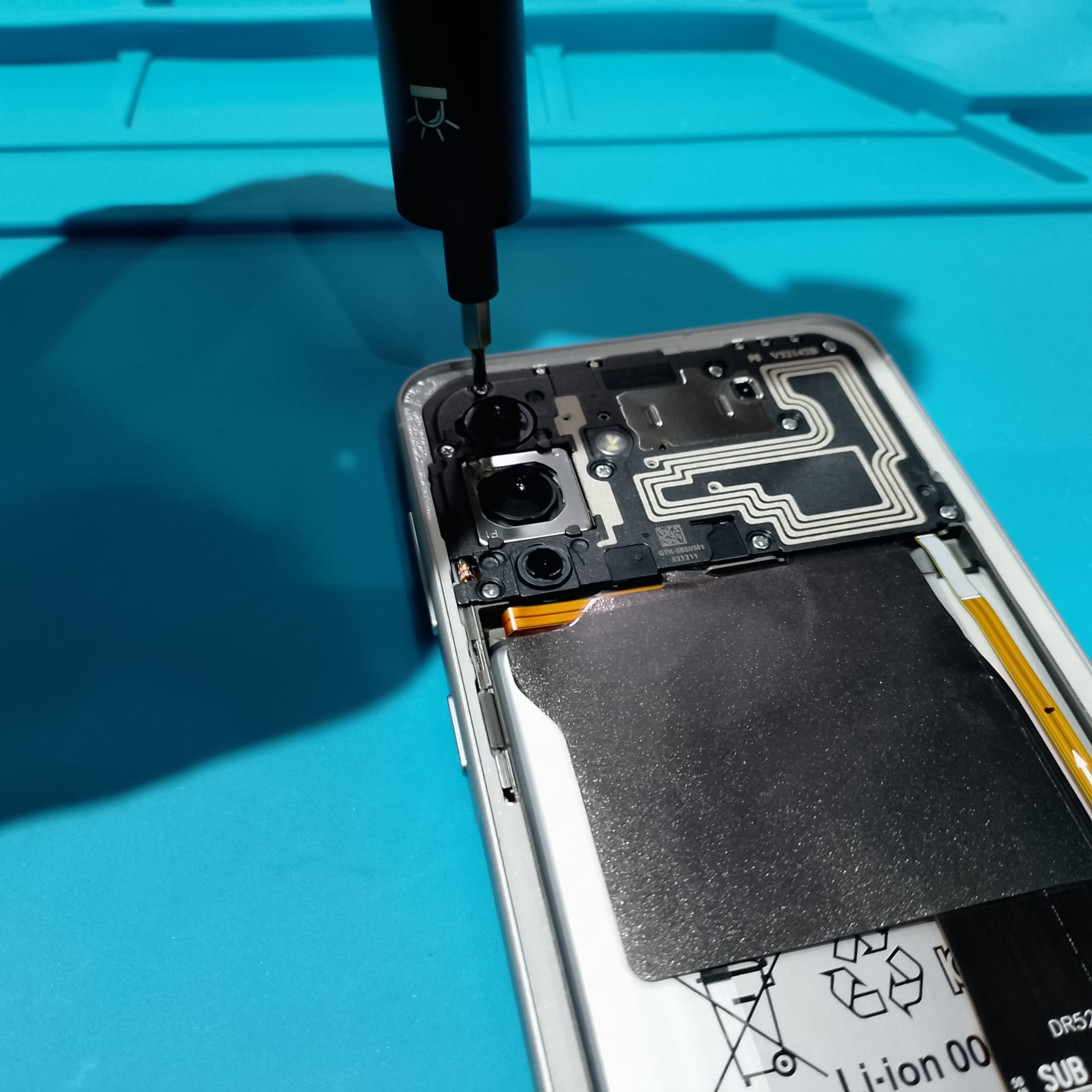 Samsung Galaxy A56 замена дисплея - Верхняя часть корпуса после снятия крышки. Перед отключением шлейфов сначала убираются винты и пластиковая защ