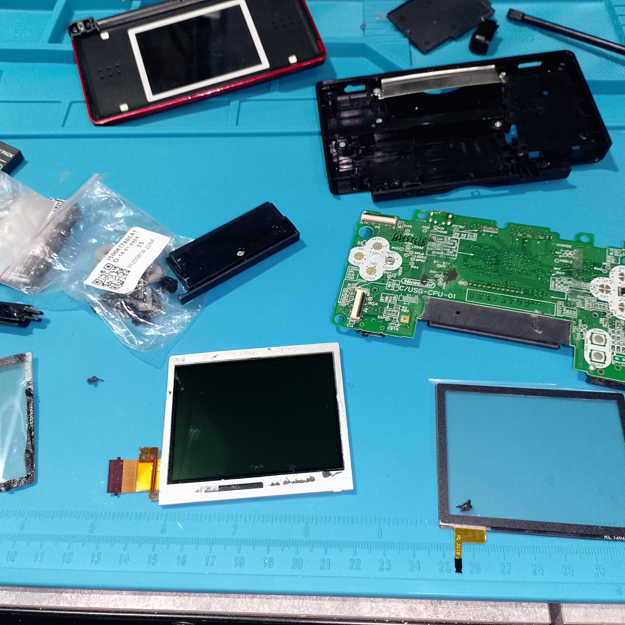 Детали Nintendo DS Lite после подготовки нижнего экрана и платы